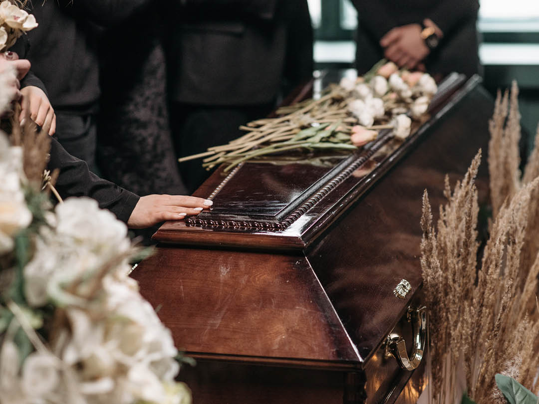 Family grieving over coffin